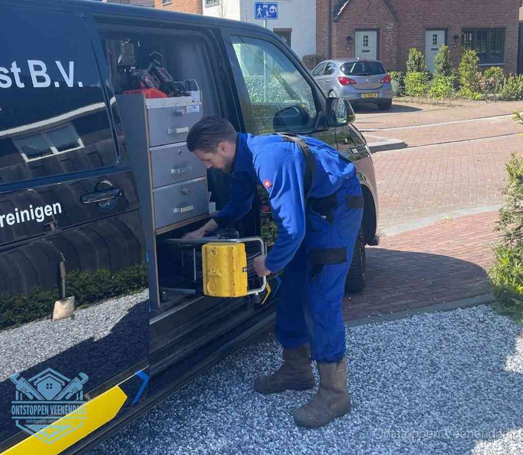 Een monteur pakt apparatuur uit de bedrijfsbus voor service aan huis, het moment om een professional in te schakelen in Veenendaal